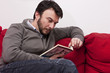 Photo: Portrait of Young Adult Relaxing and Reading a Book at Home Portrait of Young Adult Relaxing and Reading a Book at Home