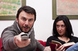 Funny Adult Couple Watching Television at Home