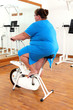 overweight woman exercising on bike overweight woman exercising on bike