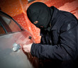 robber and the thief in a mask hijacks the car
