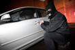 robber and the thief in a mask hijacks the car