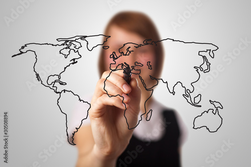 Photo: businesswoman drawing the world map in a whiteboard businesswoman drawing the world map in a whiteboard