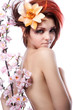Foto: Portrait of beautiful woman with cherry flowers on white Portrait of beautiful woman with cherry flowers on white