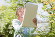 Smiling woman drawing on sketch pad outdoors