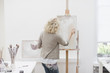 Woman painting on canvas in art studio