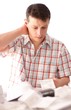 Man holding receipt while making tax computation