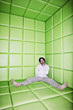 Man sitting with legs apart in padded room