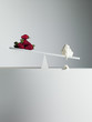 Dripping cream tipping seesaw with strawberries on opposite end