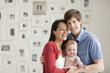 Smiling parents holding baby