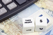 Canadian currency with calculator and dice showing TAKE PROFIT Canadian currency with calculator and dice showing TAKE PROFIT