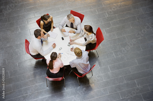 Photo: Business people having a meeting at round table Business people having a meeting at round table