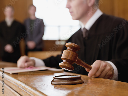 Photo: Judge holding gavel in courtroom Judge holding gavel in courtroom