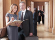 Lawyers reviewing case file in corridor