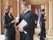 Judge and lawyer talking in corridor