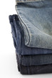 folded new blue jeans on a white background folded new blue jeans on a white background