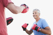 Smiling man boxing with sparing partner