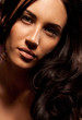 Portrait of beautiful young brunette woman with curly hair