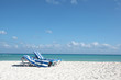 Beach chairs on perfect tropical white sand beach