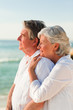 Woman hugging her husband at the beach