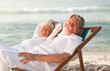 Elderly couple relaxing in their deck chairs Elderly couple relaxing in their deck chairs