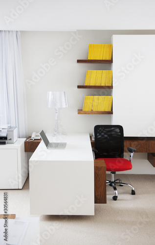 Photo: "Laptop, desk and chair in modern office" "Laptop, desk and chair in modern office"