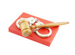 Judge's gavel and handcuffs on red legal book isolated