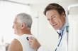 Doctor listening to man?s breathing in doctor?s office