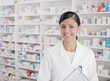 Smiling pharmacist standing in drug store