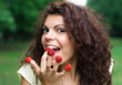 Beautiful woman eating fresh raspberry
