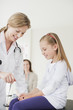 Doctor testing patient?s reflexes in doctor?s office