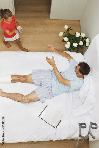 Photo: Daughter bringing coffee to father with broken leg Daughter bringing coffee to father with broken leg