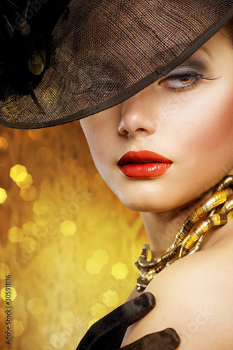 Photo: Beautiful Woman over luxury gold background Beautiful Woman over luxury gold background