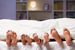 Feet sticking out from under the blanket