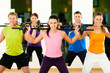 Fitness group with barbell in gym
