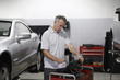 Mechanic working on computer in auto repair shop