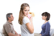 Beautiful girl with her parents arguing in the background