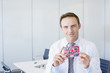Businessman  holding circuit board in office