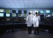 Scientists monitoring computers in control room