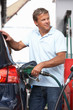 Detail Of Male Motorist Filling Car With Diesel At Petrol Statio