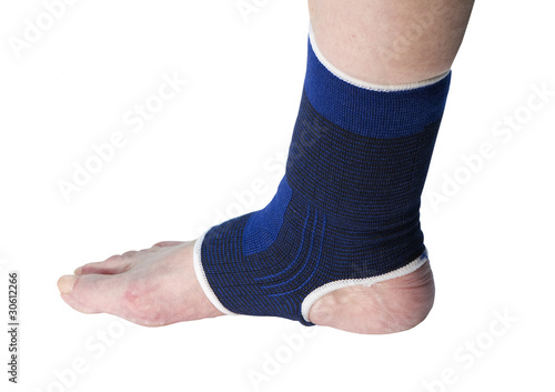 Photo: senior with ankle support on a white background senior with ankle support on a white background