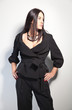 Portrait of a beautiful brunette in a stylish fashion pantsuit