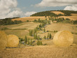 "Hay bale and rolling landscape, Tuscany, Italy"