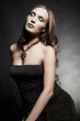 Photo: Portrait of young beautiful woman in an elegant evening dress Portrait of young beautiful woman in an elegant evening dress