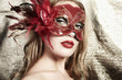 Photo: Beautiful young woman in a red mysterious venetian mask Beautiful young woman in a red mysterious venetian mask