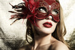 Photo: Beautiful young woman in a red mysterious venetian mask Beautiful young woman in a red mysterious venetian mask