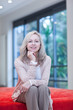 Smiling mature woman sitting on futon