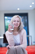 Smiling mature woman holding glass of water