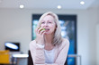 Mature woman eating an apple