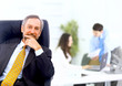 business man leading a team in an office environment