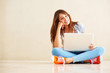 Girl using laptop and smiling